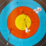 close up of an archery board with arrows stuck on several targets | archery west roxbury