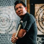 a man holding an axe in front a target | axe throwing West Roxbury